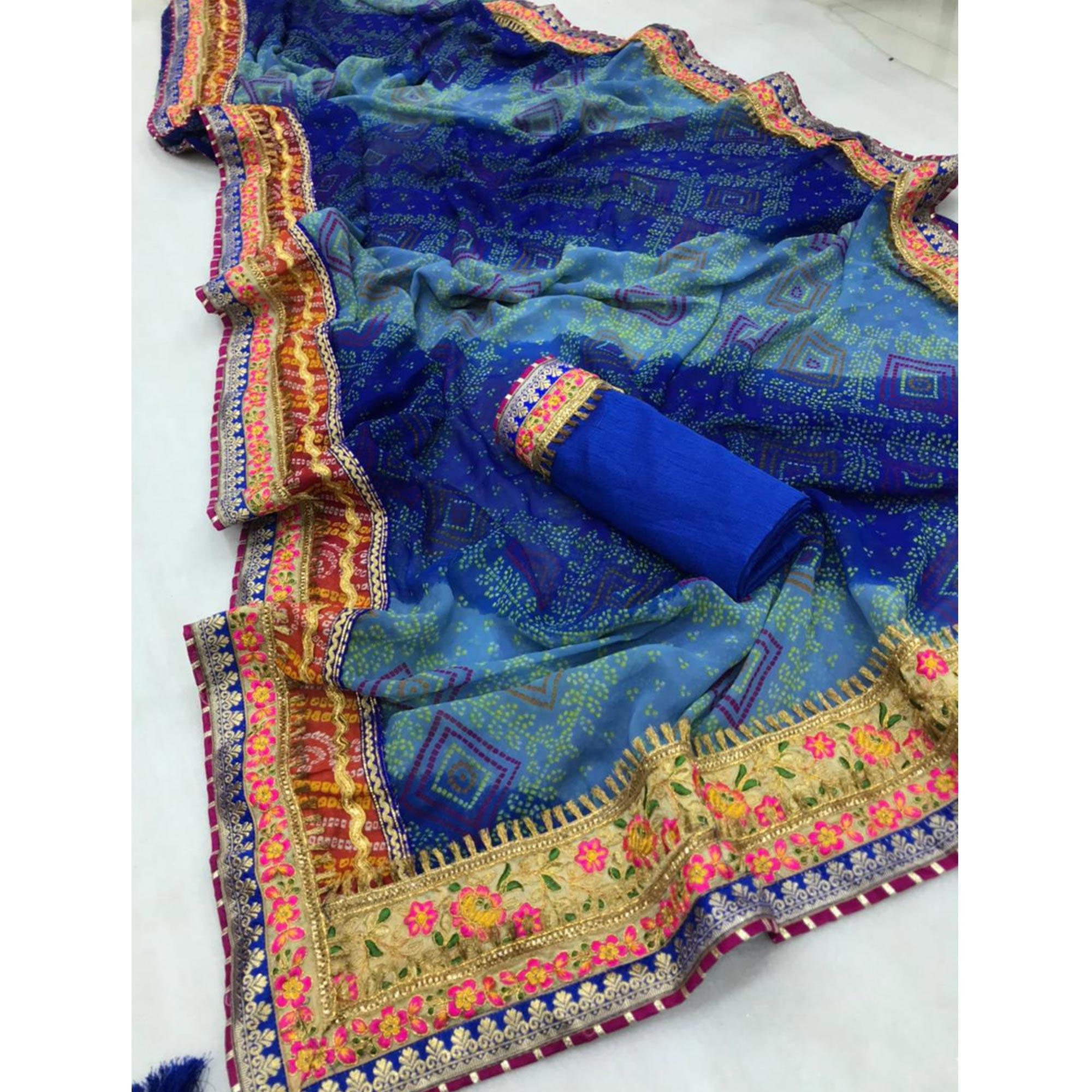 Engrossing Blue Colored Festive Wear Bandhani Print With Zari Border Work And Latkan Heavy Georgette Saree - Peachmode