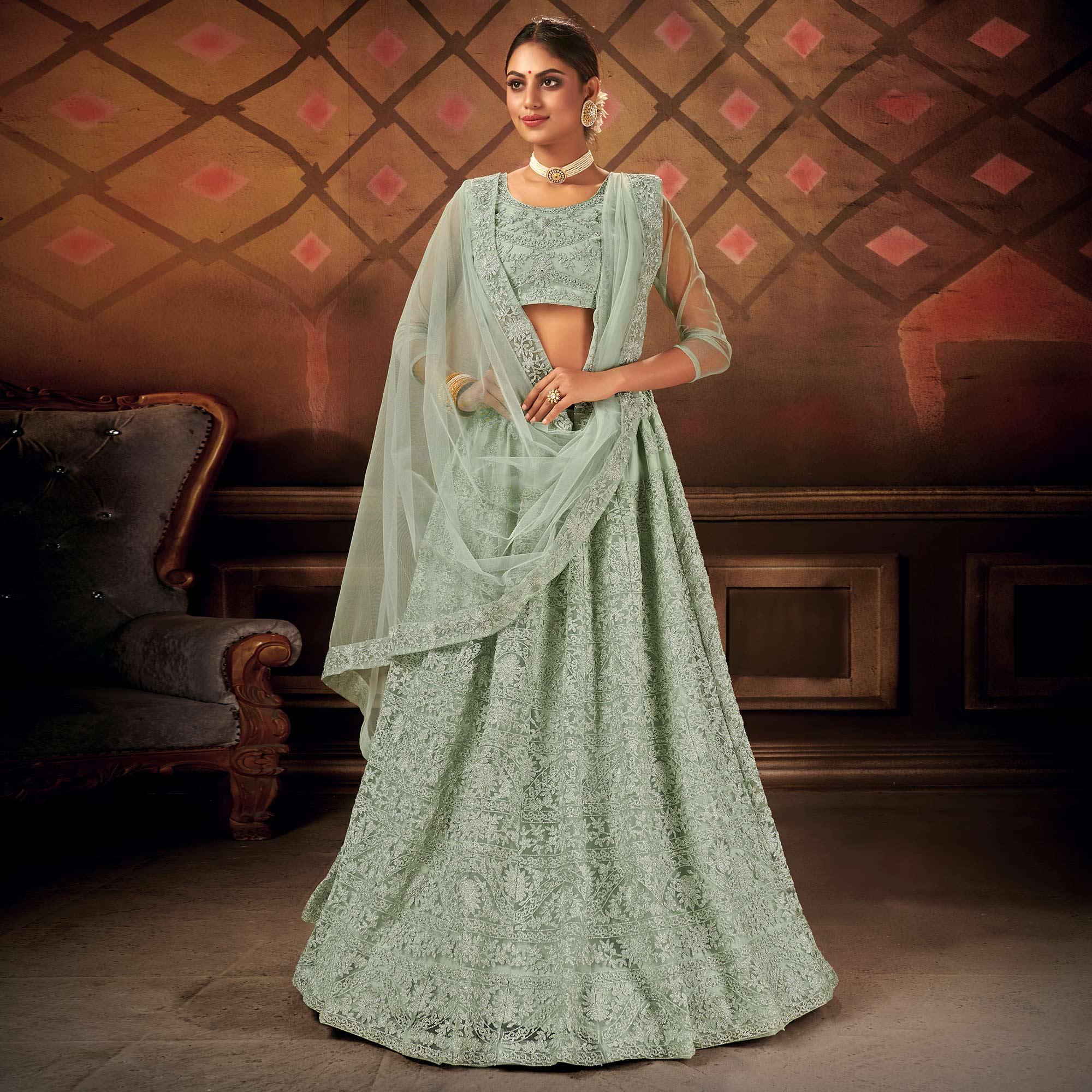 Exceptional Pastel Green Colored Partywear Embroidered Net Lehenga Choli - Peachmode