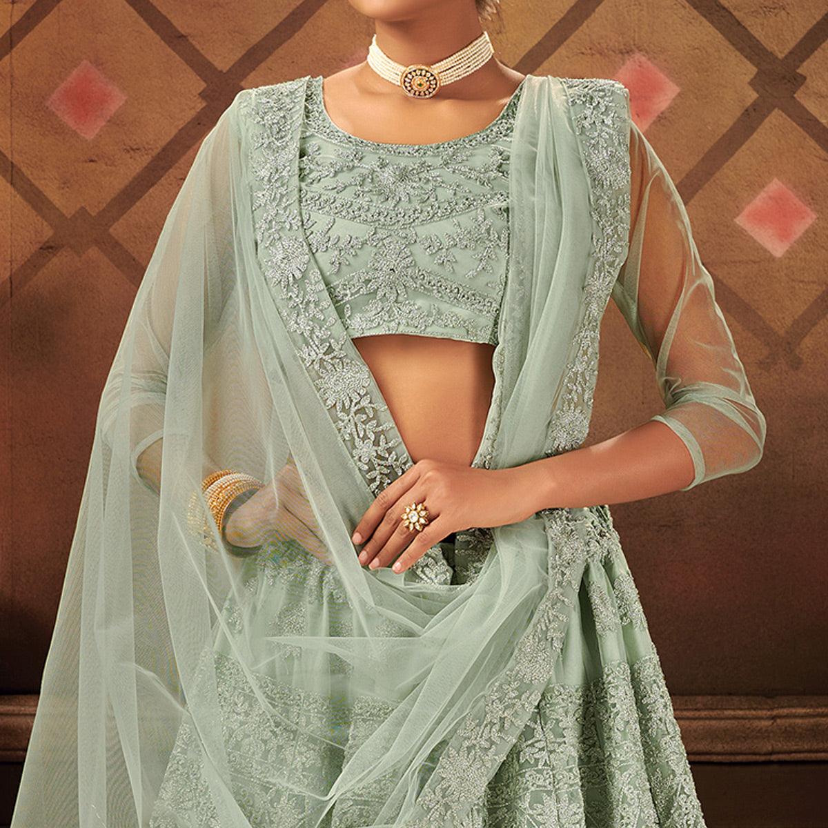 Exceptional Pastel Green Colored Partywear Embroidered Net Lehenga Choli - Peachmode