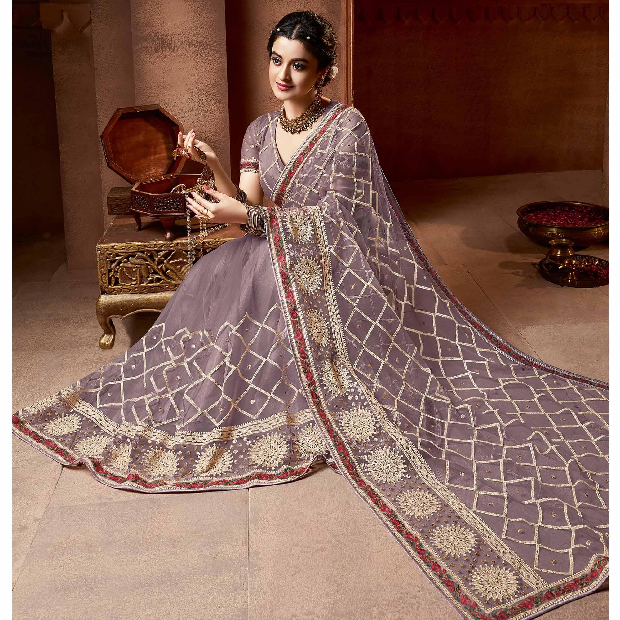 Exclusive Mauve Coloured Partywear Embroidered Soft Net Saree - Peachmode