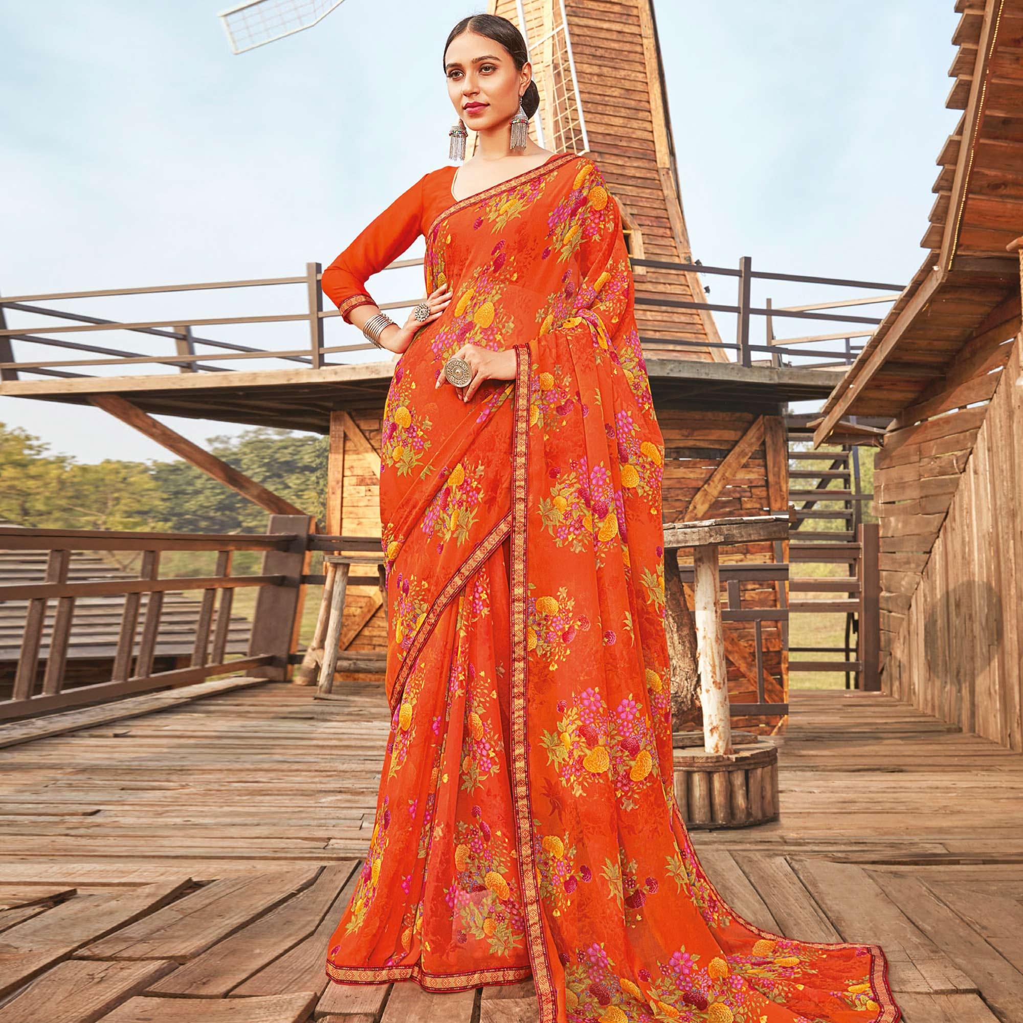 Eye-catching Orange Coloured Partywear Pure Georgette Floral Printed Saree With Fancy Lace Border - Peachmode