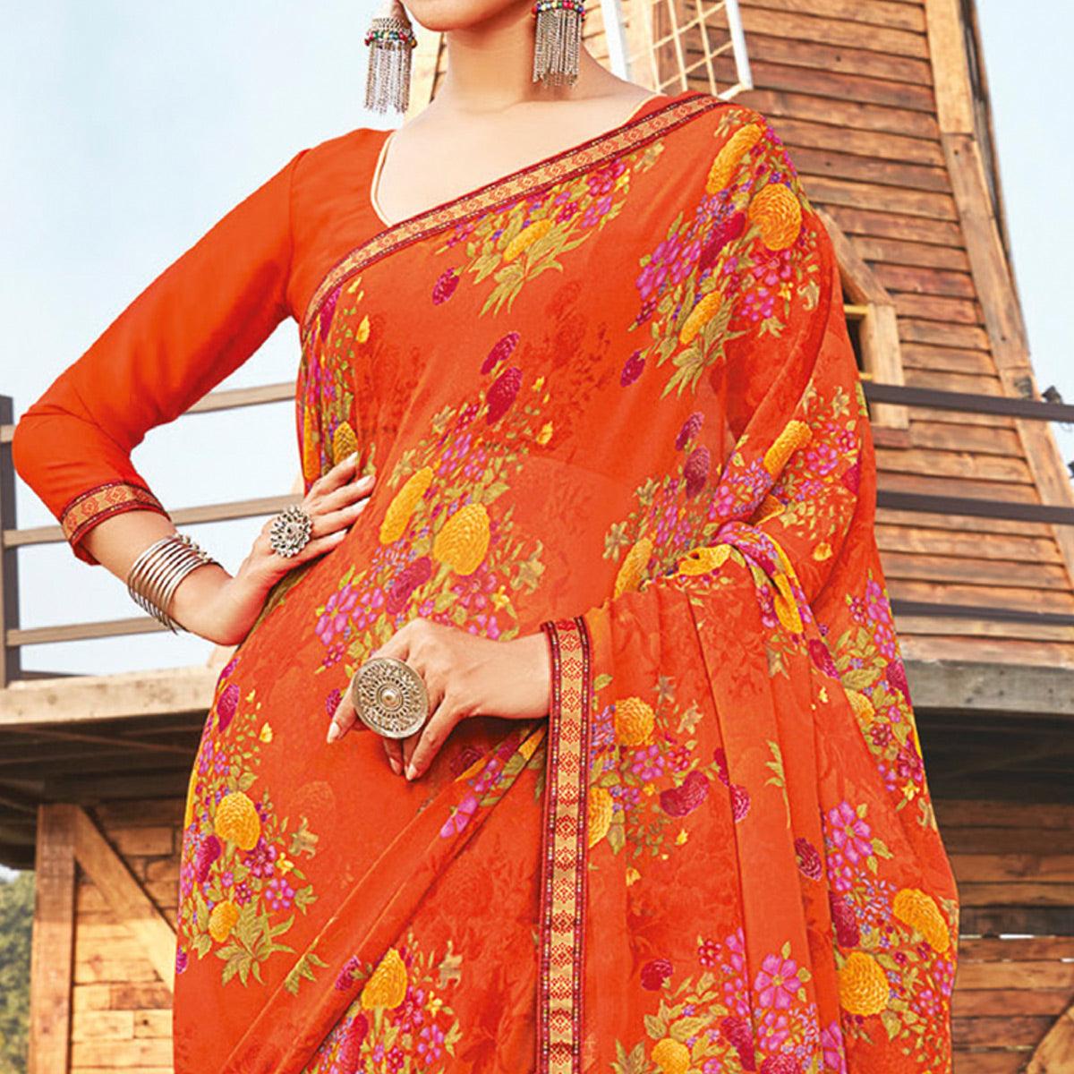 Eye-catching Orange Coloured Partywear Pure Georgette Floral Printed Saree With Fancy Lace Border - Peachmode