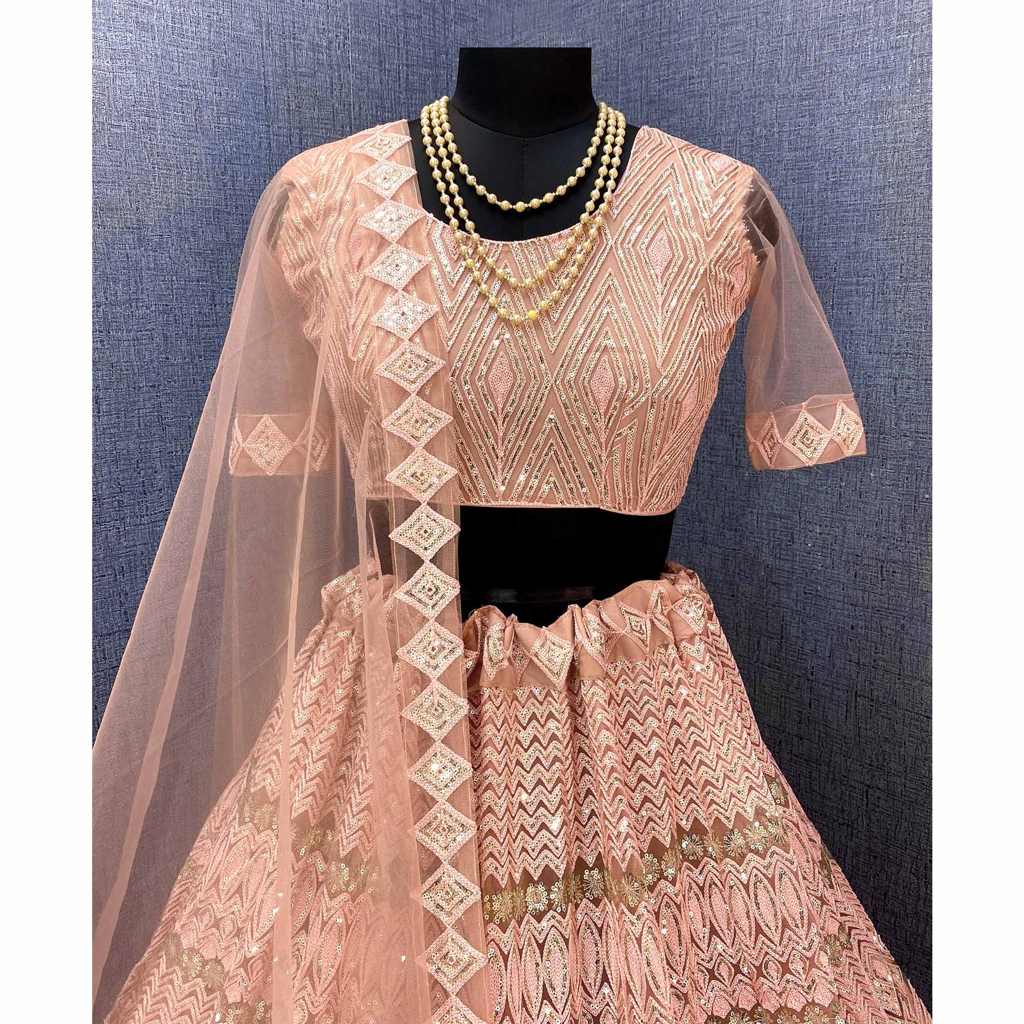 Peach Sequins Embroidered Netted Lehenga Choli