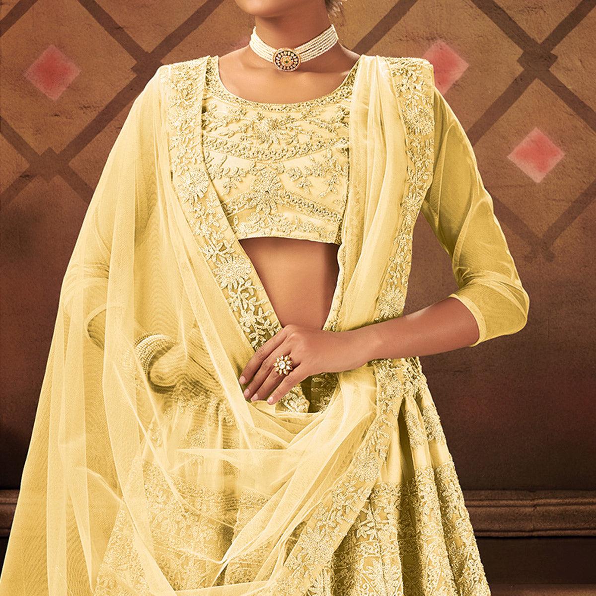 Glowing Yellow Colored Partywear Embroidered Net Lehenga Choli - Peachmode