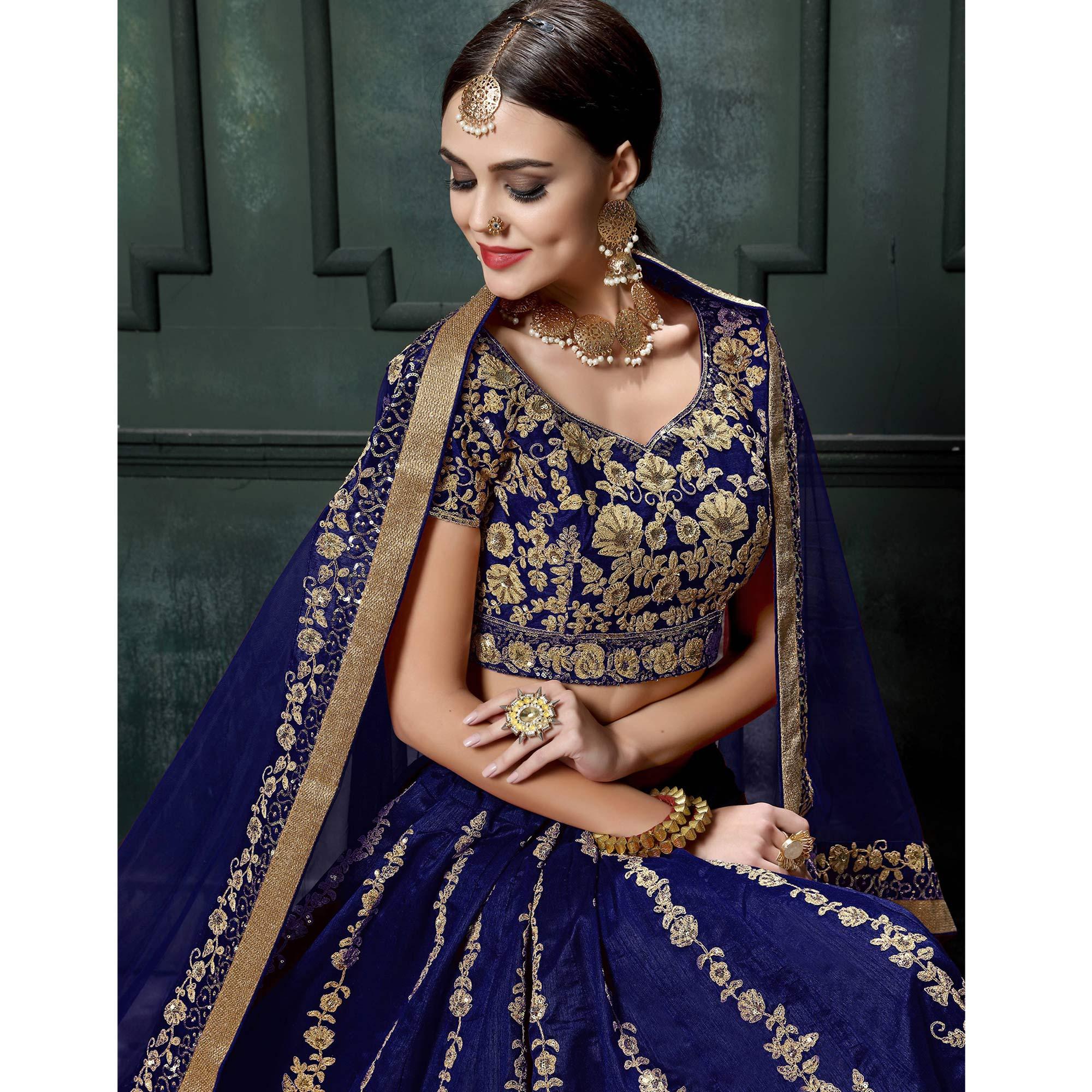 Prominent Blue Colored Wedding Wear Embroidered Raw Silk Lehenga - Peachmode