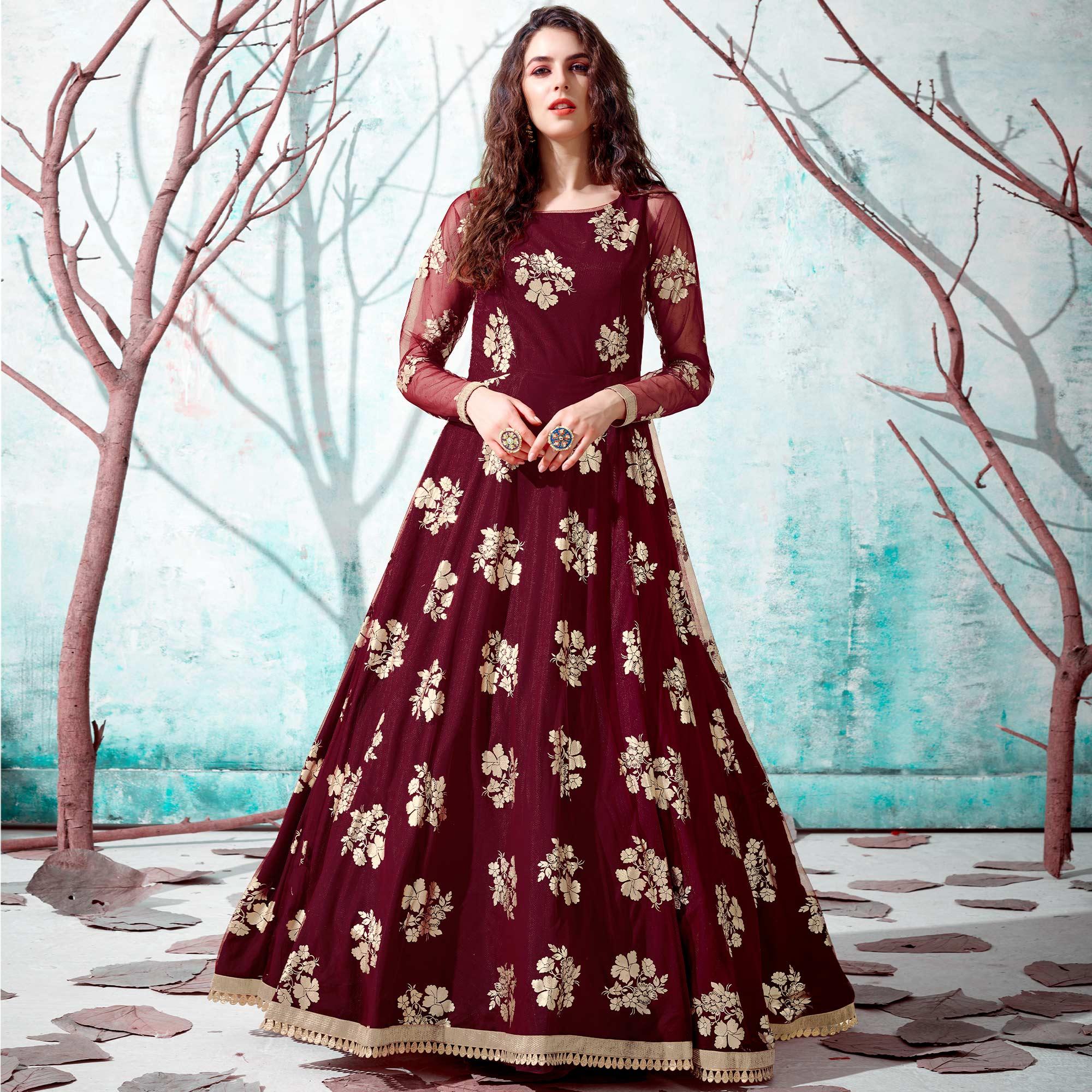 Ravishing Maroon Coloured Partywear Metallic Foil Work Net Gown - Peachmode