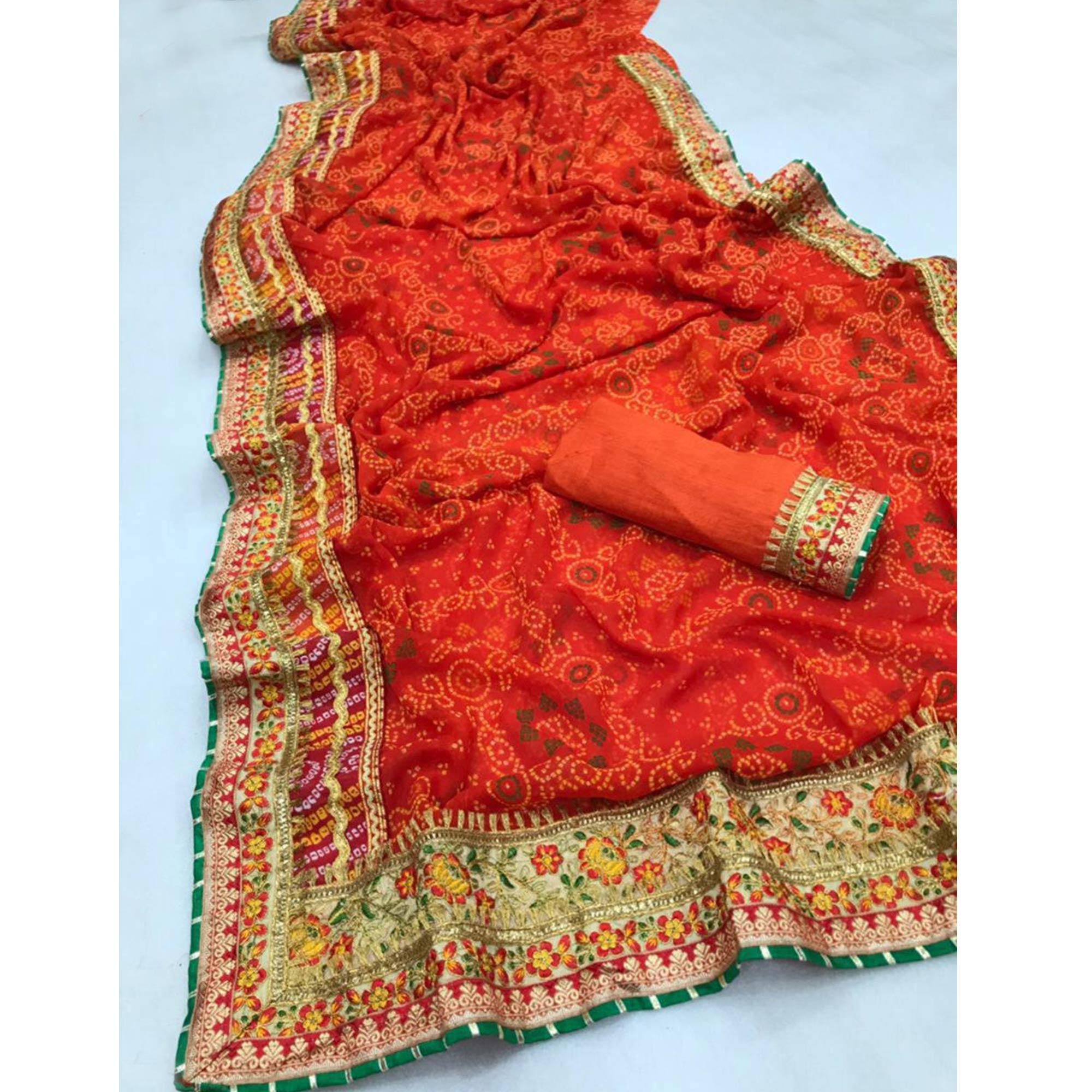 Ravishing Orange Colored Festive Wear Bandhani Print With Zari Border Work And Latkan Heavy Georgette Saree - Peachmode