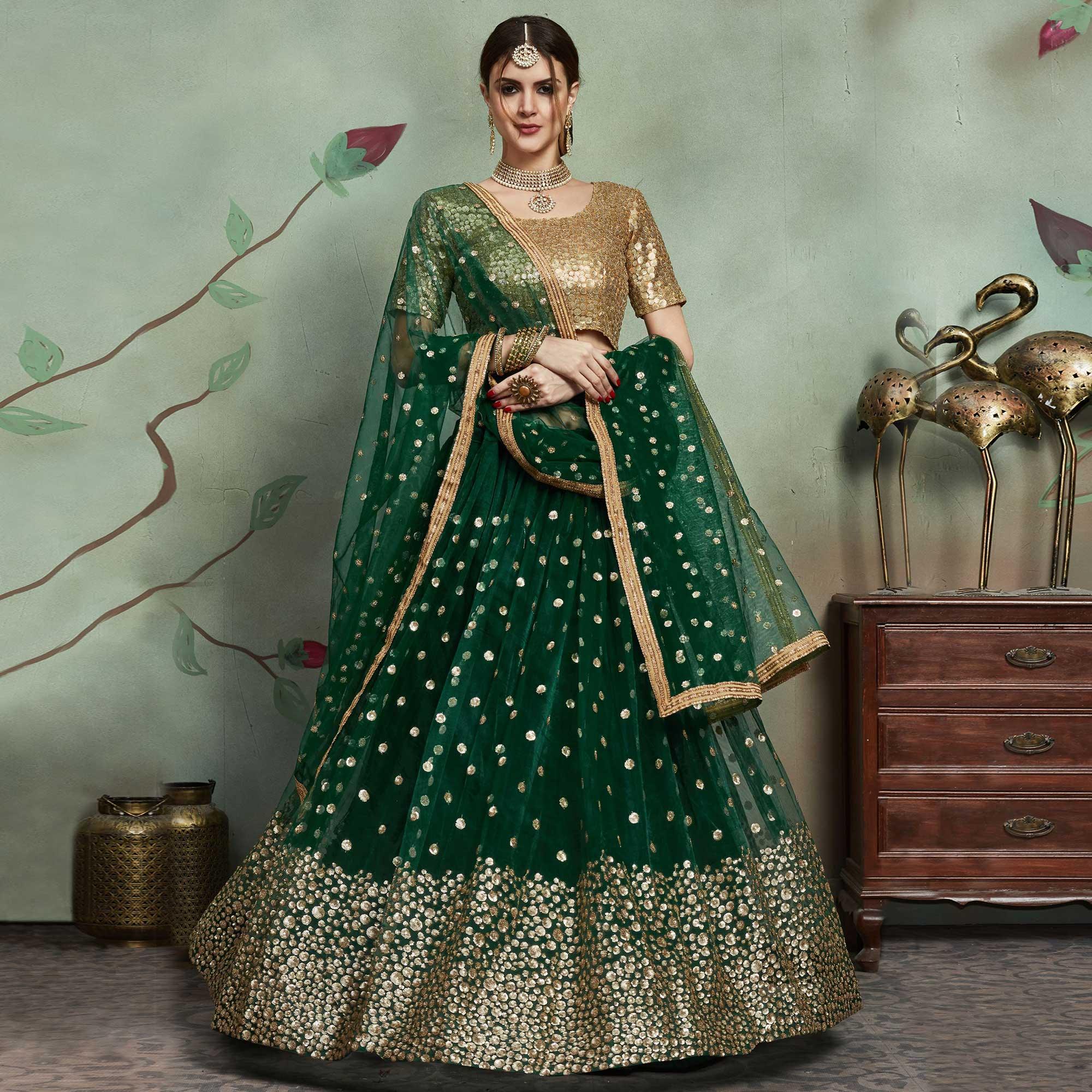 Refreshing Dark Green Colored Partywear Sequins Work Netted Lehenga - Peachmode