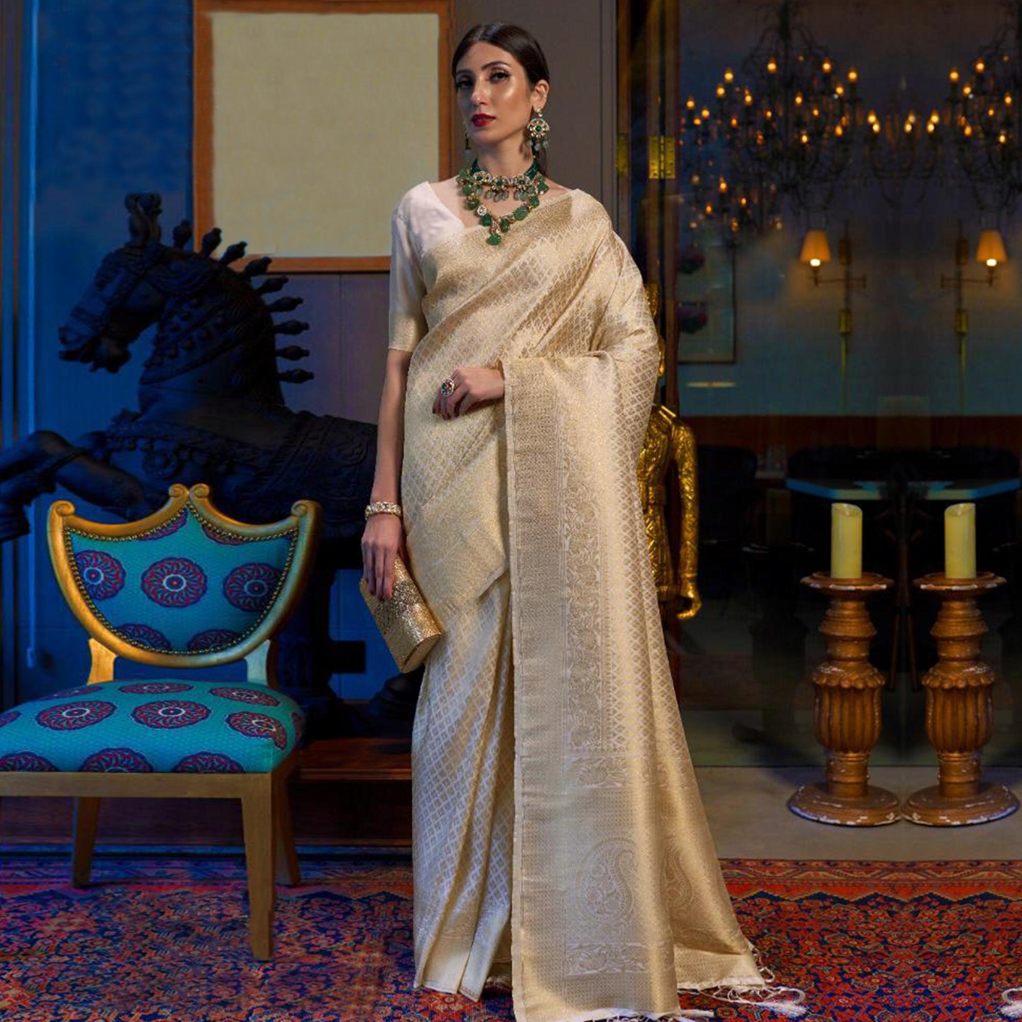 Staring Cream Colored Festive Wear Woven Silk Saree With Tassels - Peachmode