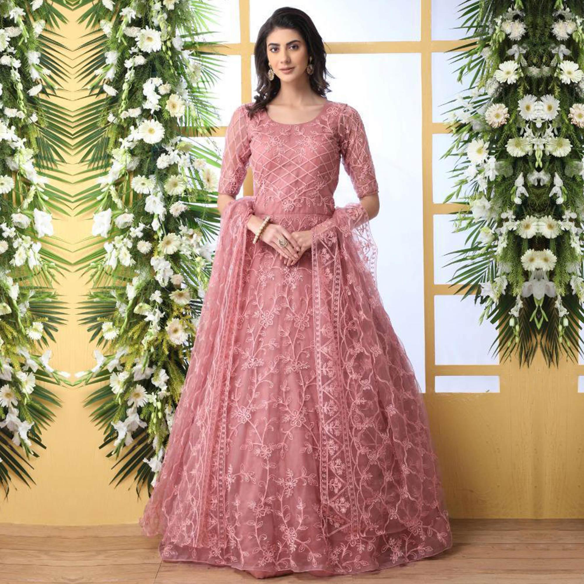 Unique Dusty Peach Colored Party Wear Embroidered Net Gown With Dupatta - Peachmode
