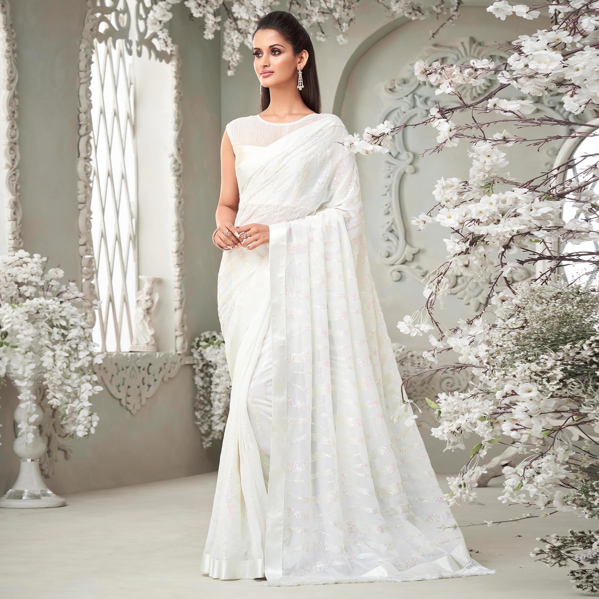 White Sequence Embroidered Georgette Saree With Tassels - Peachmode