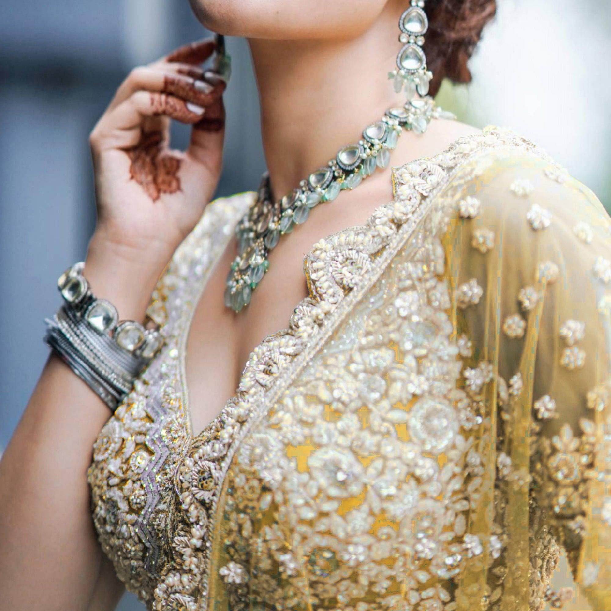 Yellow Heavy Embroidered Netted Lehenga Choli - Peachmode