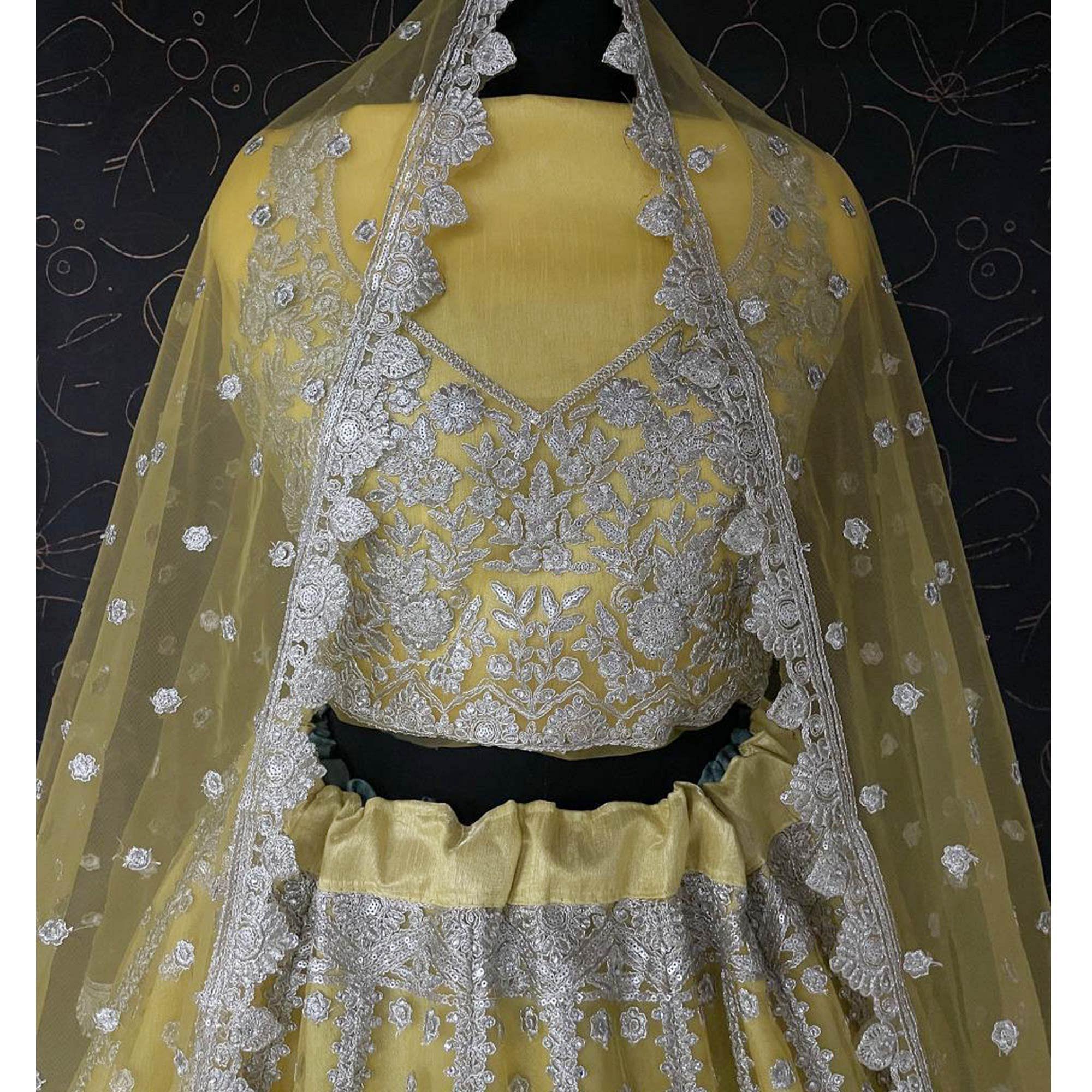Yellow Heavy Embroidered Netted Lehenga Choli - Peachmode