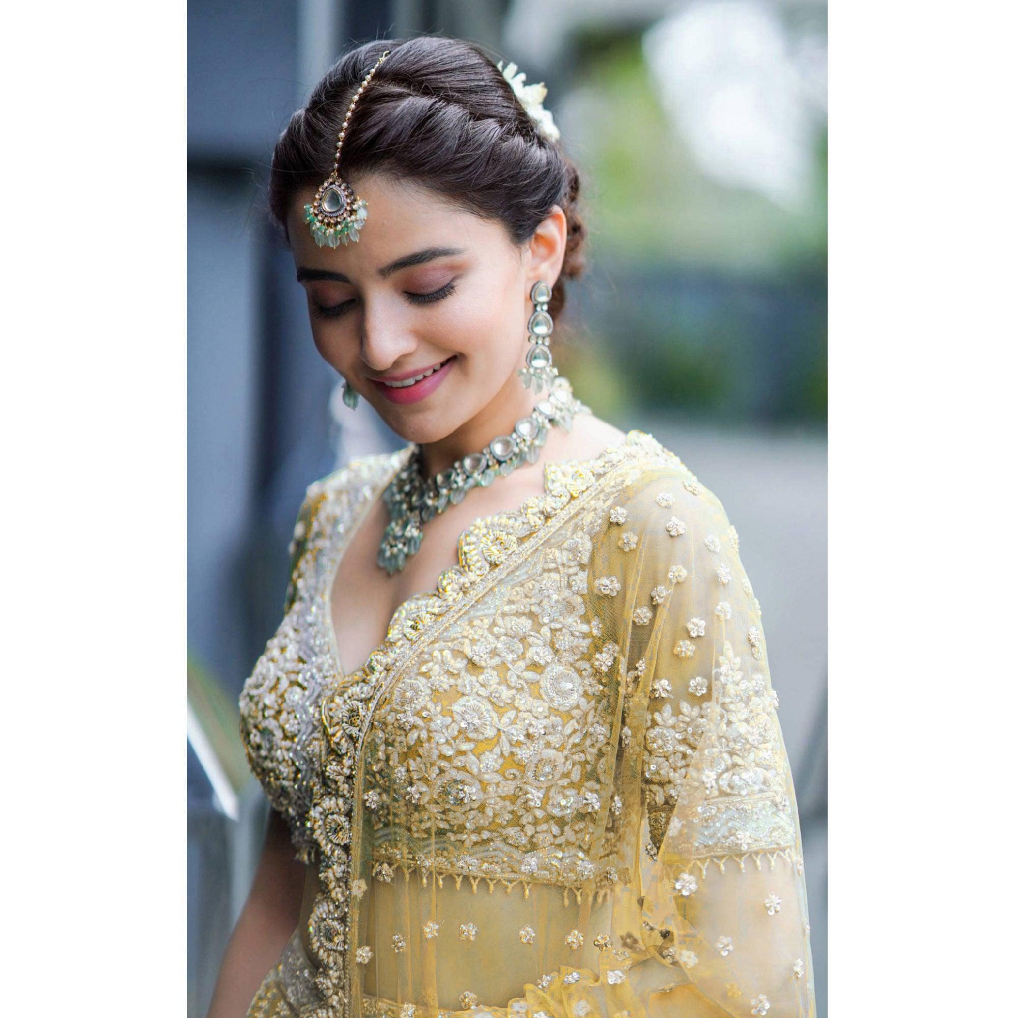Yellow Heavy Embroidered Netted Lehenga Choli - Peachmode