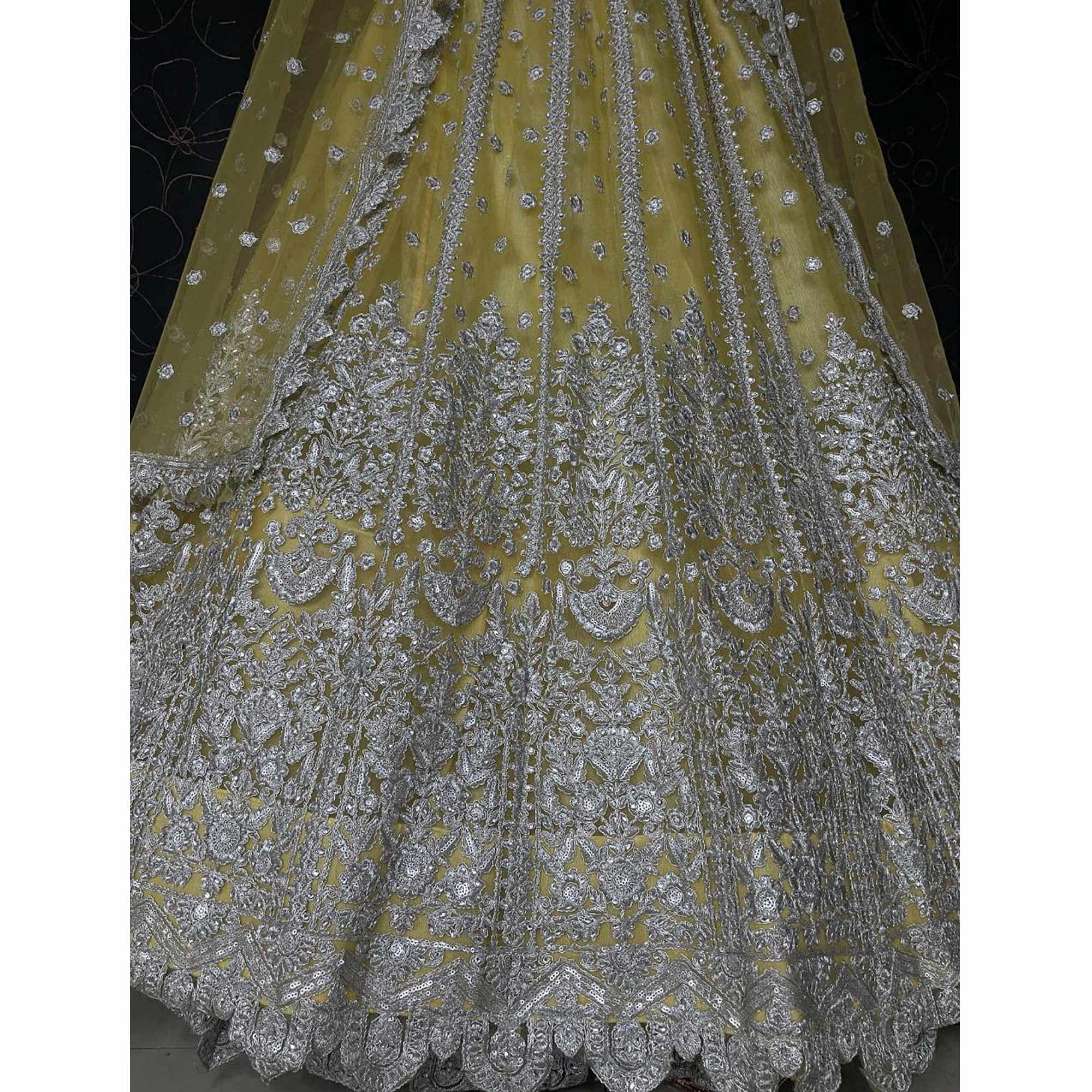 Yellow Heavy Embroidered Netted Lehenga Choli - Peachmode